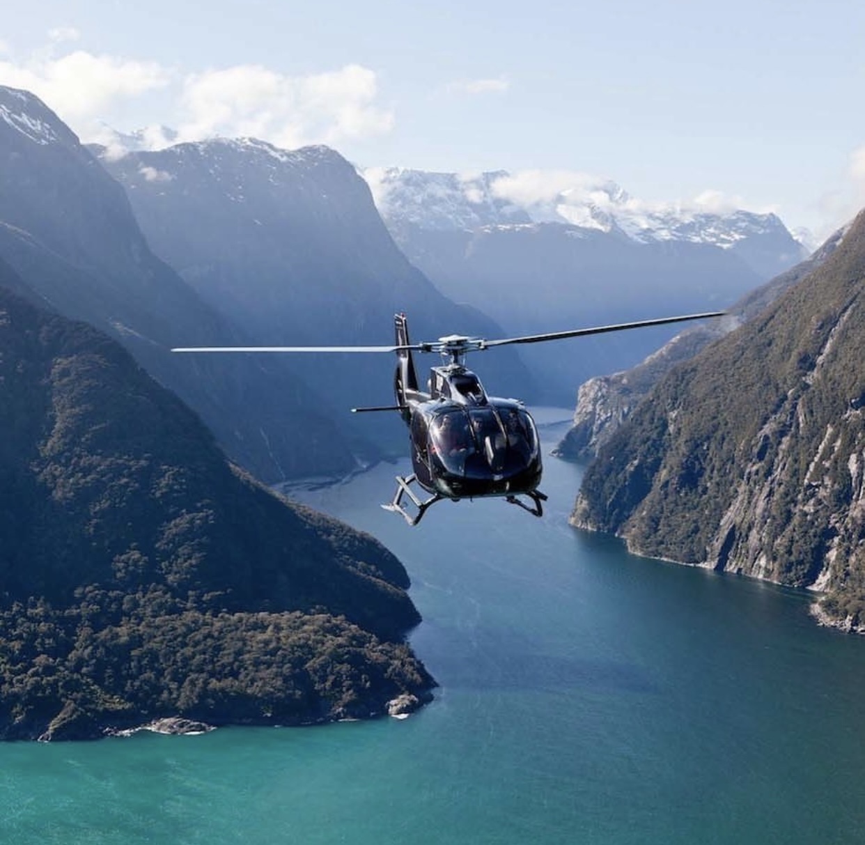 Helicopter over Hardangerfjord with waterfalls in Western Norway